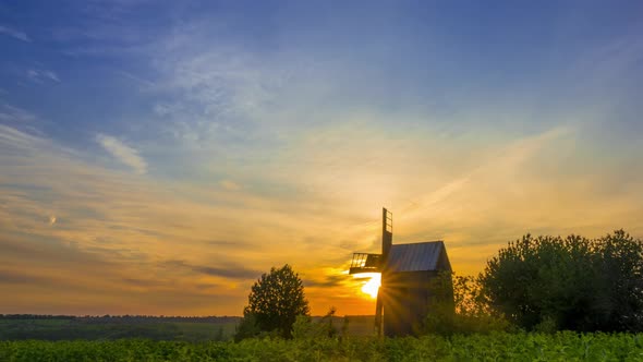 Sunrise and an Old Wooden Windmill