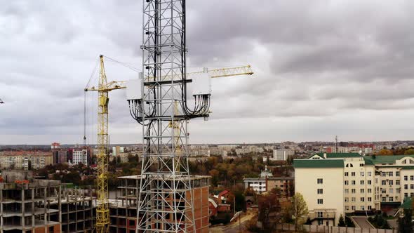 4G and 5G telecommunications tower cellular network antenna on the roof of a building. alt