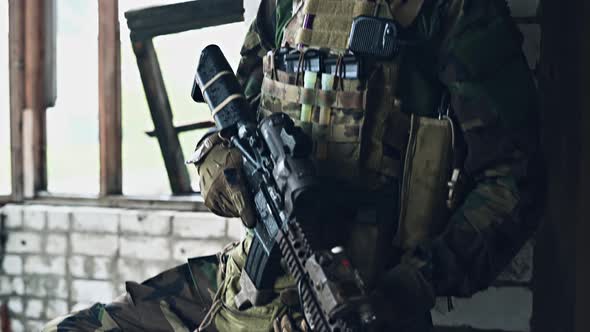 A Thoughtful Soldier, Resting From a Military Operation While It Is Raining Outside. alt