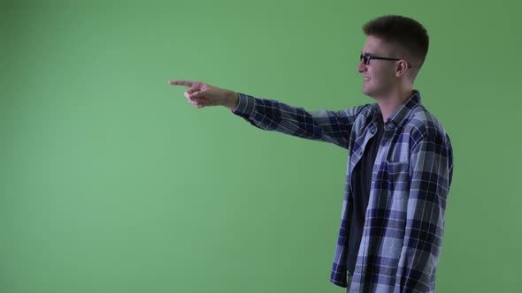 Profile View of Happy Young Hipster Man Pointing Finger alt
