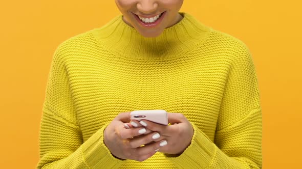 Attractive Female Scrolling Social Networks App in Smartphone, Showing Ok Sign alt