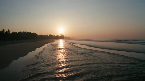 Sunrise on a Sandy Beach in the Southern Part of the Island of Sri Lanka. Surfers