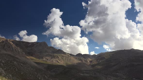 Camera Movement Rotating With Clouds in Treeless Mountainous Hills alt