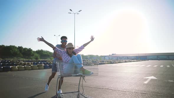 Young Friends Having Fun on Shopping Trolleys alt