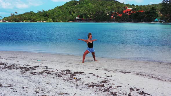 Sexy beauty models travelling spending quality time at the beach on clean white sand and blue backgr alt