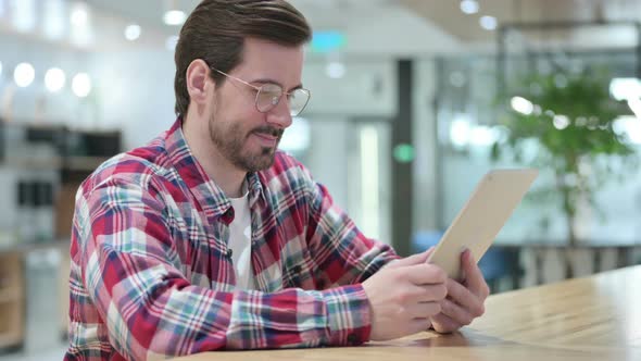 Serious Professional Male Designer Using Tablet  alt