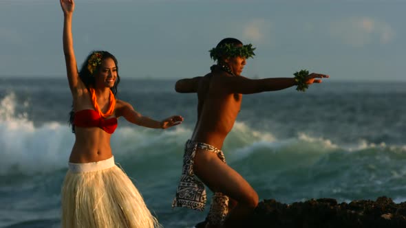 Polynesian dancers perform by ocean, slow motion alt