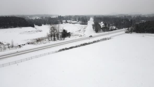 Aerial view of rural highway and residential neighborhood in the winter.