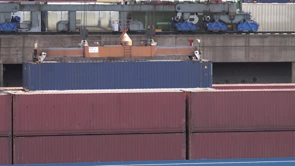 Gantry Crane Is Loading a Container To a Ship at Daytime in the Port of Duisburg - Germany alt