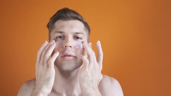 Portrait of a Beautiful Young Man with Transparent Patches for Dark Circles Under the Eyes, Enjoy alt