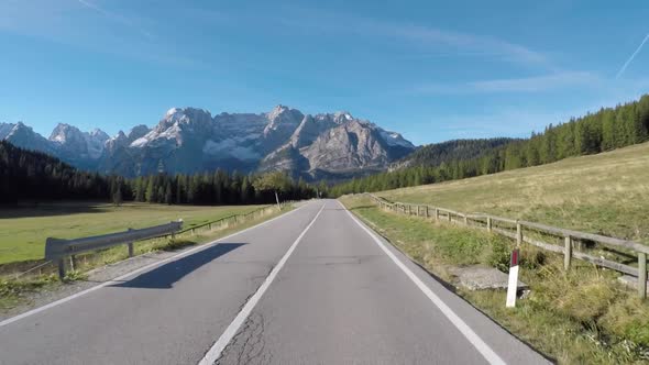 Driving on Italian alps with beautiful mountains on background
