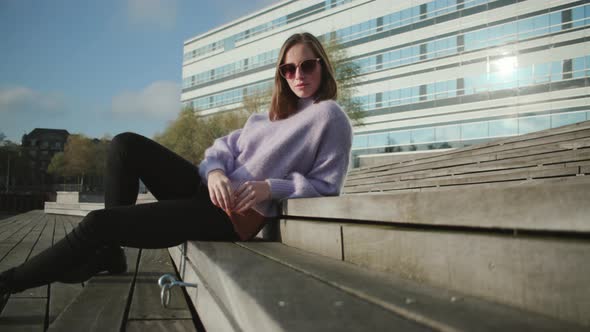 Brunette Woman In Sunglasses And Jumper
