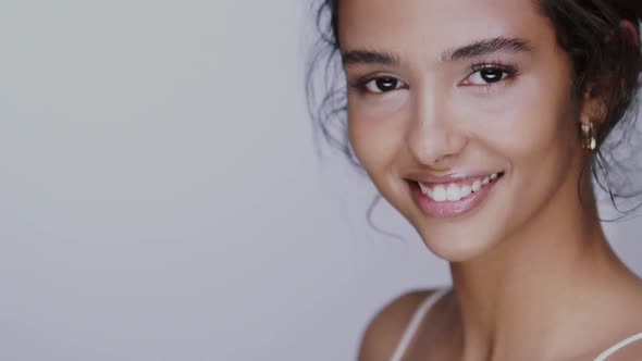 Pretty Girl with Black Hair Fixed Behind, Big Eyes, Thick Eyebrows and Naked Shoulders at Gray alt