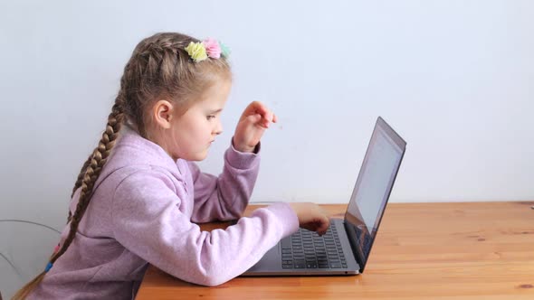The Child Learns While Sitting at the Laptop