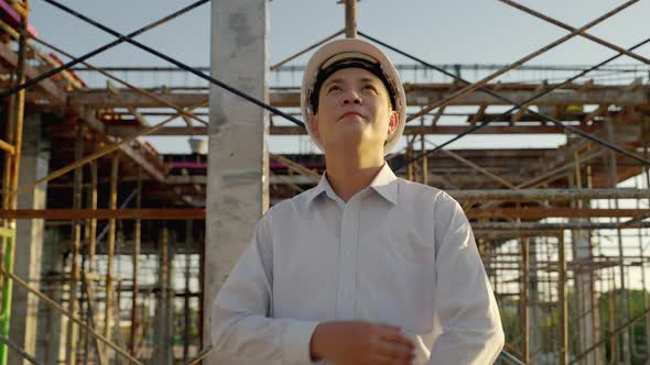 asian man engineers are proudly in their company's portfolio. Engineers stand and cross one's arm alt