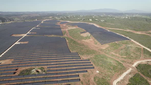 Huge expanse of solar panels in rural area at Lagos in Portugal. Aerial circling
