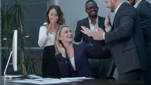Business team applauding during meeting in the office