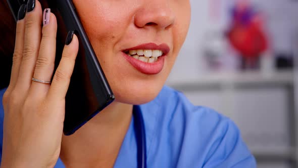 Healthcare Physician Consulting Remote Patients Using Phone alt