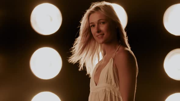 Beautiful Woman In Front Of A Wall Of Lights alt