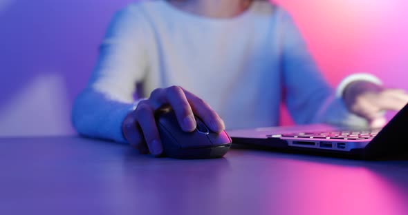 Woman Using Notebook Computer Under Cyber Lighting Color alt