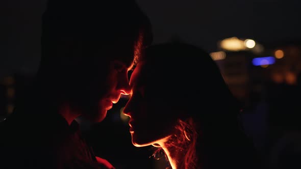 Couple Hugging By the Light of Street Lamps