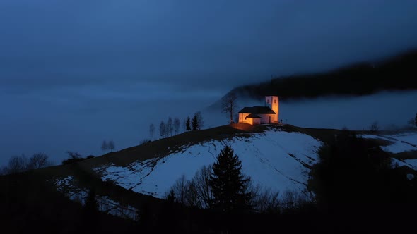 Church of St. Primoz and Felicijan at Night. Jamnik, Slovenia. Aerial View alt