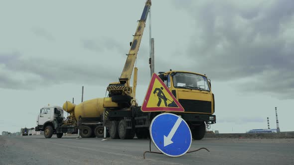 Workers Install a Pole with Street Light By Automobile Crane Along the Road. Construction Machinery alt