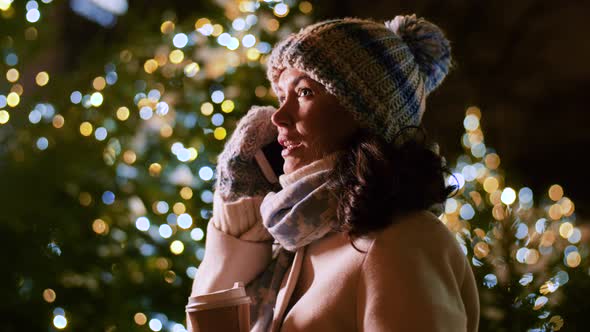 Happy Woman Calling on Smartphone on Christmas alt