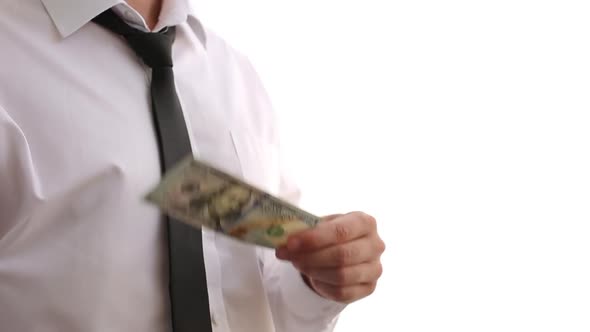 A Man In A White Shirt Waves Dollars. Shows Money. Businessman Made Money