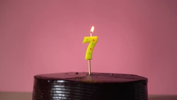 Chocolate Birthday Cake with Wick Lighting Trying to Blowout Candle alt