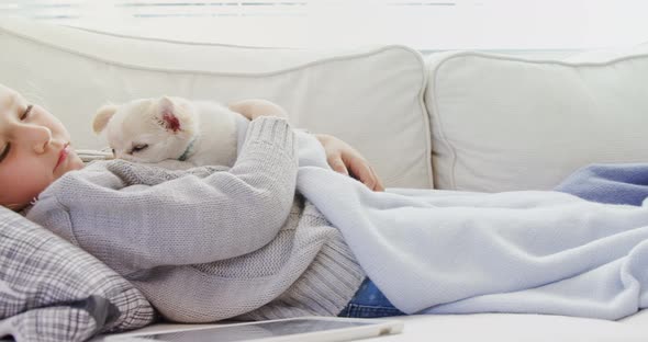 Little girl sleeping on sofa holding her pet in her arms 4K 4k alt
