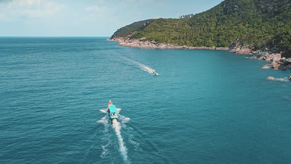 Aerial Boat Sails on Blue Sea Water Near Island alt