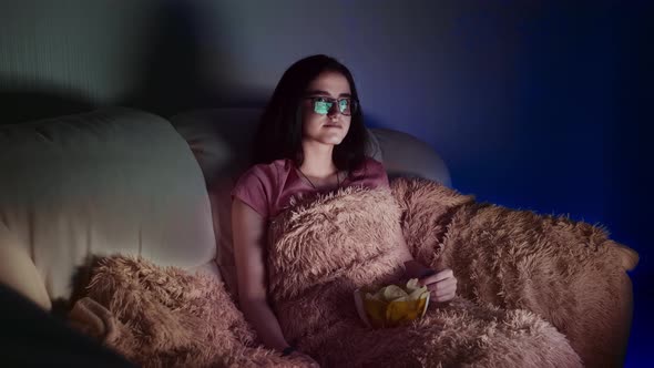 Pretty Girl Watches Tv in the Evening Switches Channels and Eats Chips Relaxing at Home in Front of alt