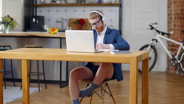 Businessman in Underpants and Jacket Having Video Call Working at Home