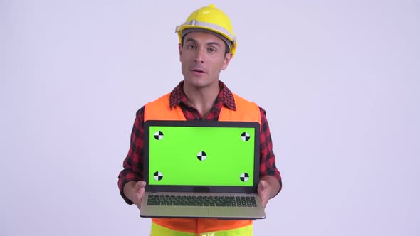 Young Happy Hispanic Man Construction Worker Talking While Showing Laptop
