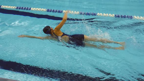 Female Amateur Athlete Practicing Front Crawl In Swimming Pool