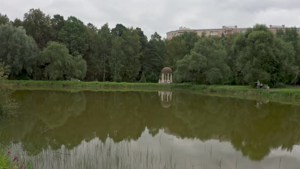 A White Rotunda on the Shore of a Small Pond in the Summer