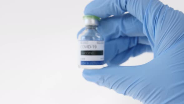 COVID19 Vaccine in Researcher Hands Doctor Takes Ampoule in Hand with Vaccine for Coronavirus Cure alt