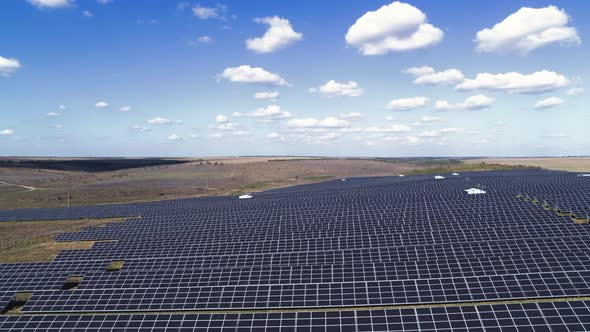 Aerial View of Green Field with Solar Panels