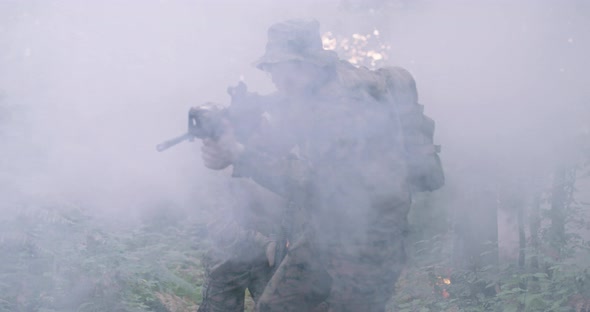 Soldiers Taking Aim From Rifle in Forest Smoke in Background Military and Army Concept alt