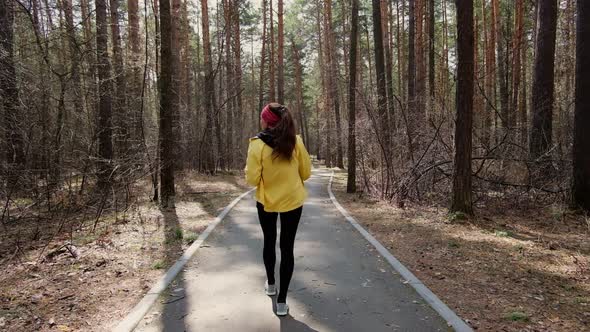 Girl runner runs in the park goes for sports. runner athlete girl running on trail nature. alt