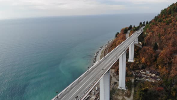 Aerial View of the Highway Viaduct on Concrete Pillars in the Mountains, Drone Flight Over  alt