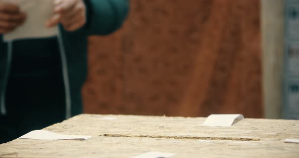 Person casting a ballot during elections