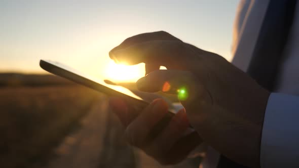 the Hands of a Man Are Driving Their Fingers Over the Tablet. Close-up. Man Checks Email alt