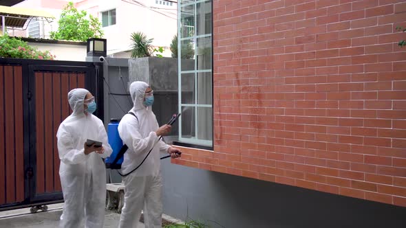 Man and women wear protective suits, goggles and masks making disinfection and decontamination  alt