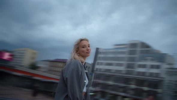 Smiling Woman Urban Background Looking Camera in Evening City alt