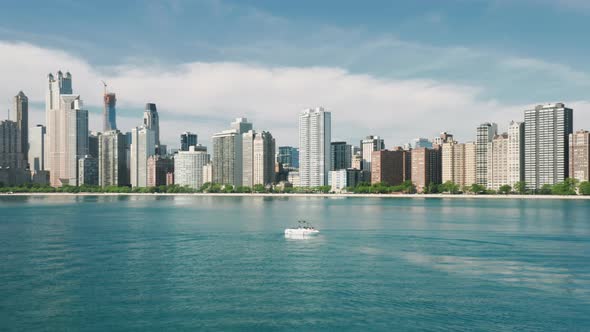 Aerial Sailing Boat in Michigan Lake with Downtown Chicago on Motion Background alt