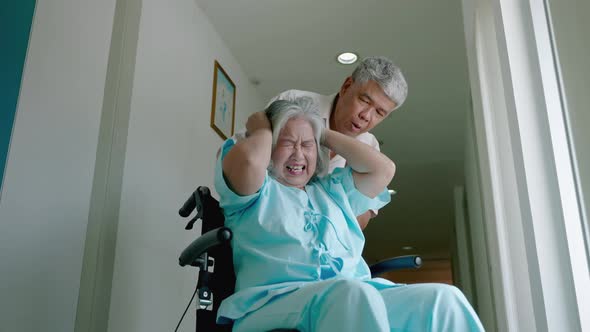 elderly woman with psychiatric symptoms is in a wheelchair with an elderly couple caring for her wit