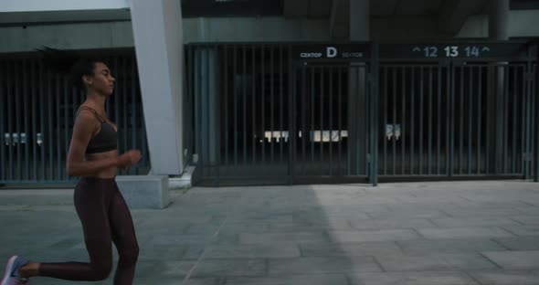 AfricanAmerican Mixed Race Woman Runs Fast in the Morning alt