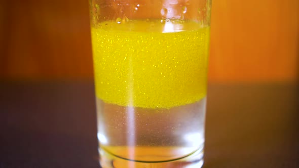 Time lapse of water and oil separating into two layers in a glass. alt